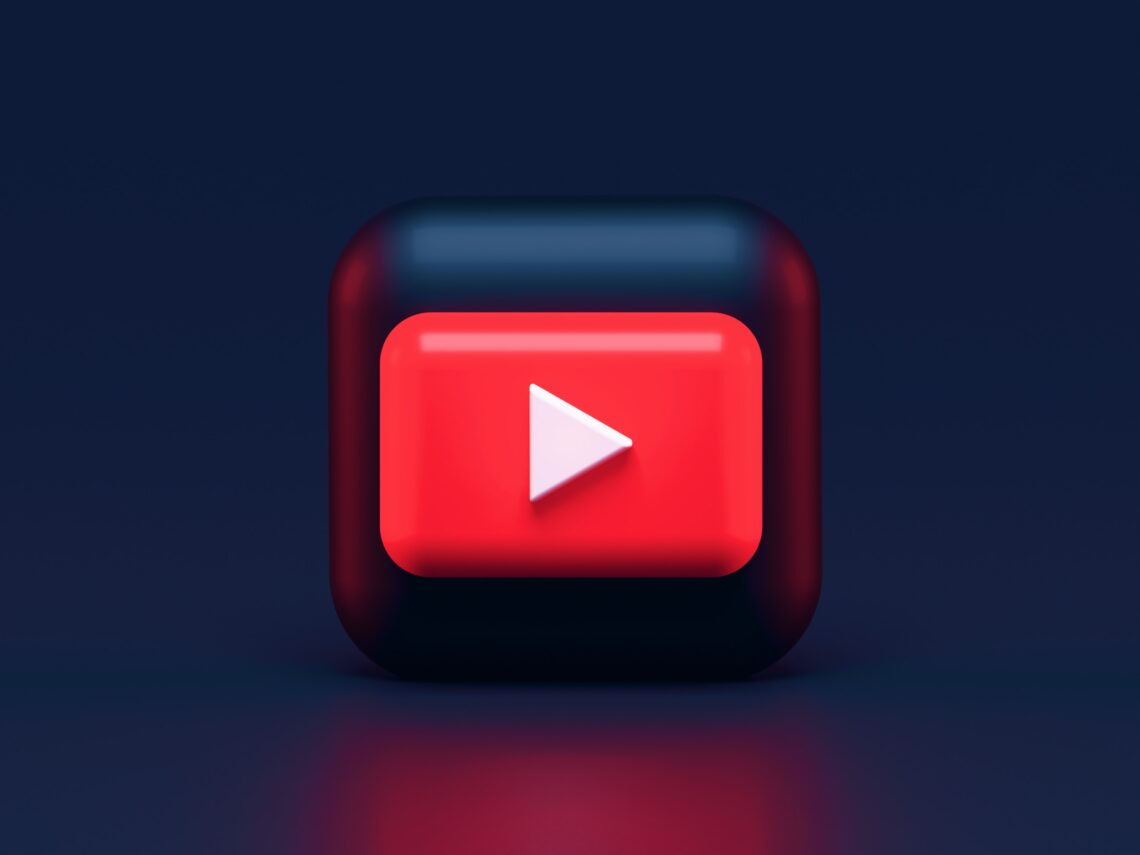 Photo: Dark background with animated, square icon of Youtube symbol in the middle (symbol is a red square with a white play button in the centre).